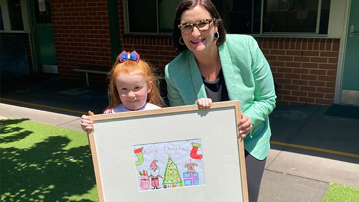 Doggone it - Hayley Shepherd and Education Minister Sarah Mitchell hold Hayley's winning design from last year.